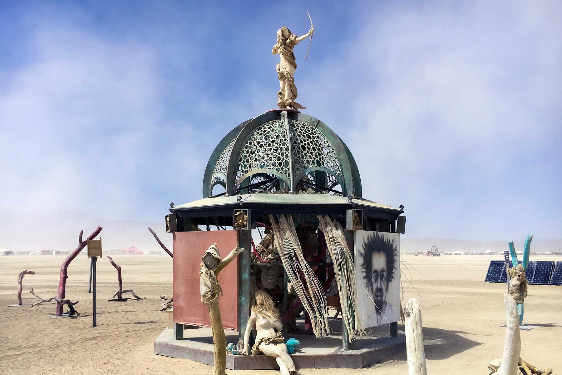 Secretly Abandoned Spaces by day: a weathered domed pavilion topped by an archer figure, with tattered curtains, cast figures and a charcoal portrait