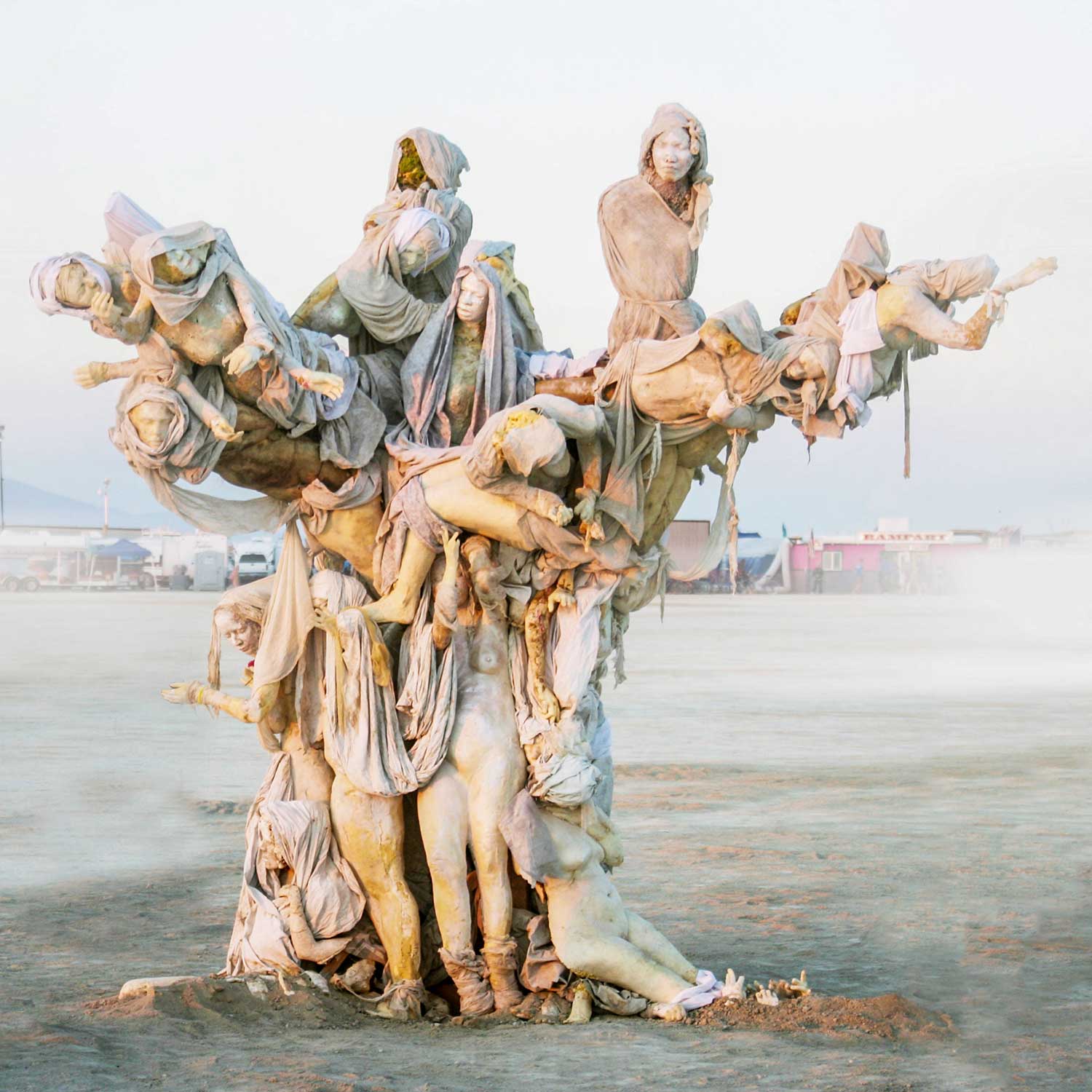 Womantree in a hazy dust storm, its pale figures rising from the misty playa
