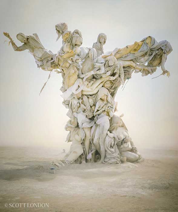 Womantree in a whiteout dust storm, its branches of cast figures emerging from the pale haze