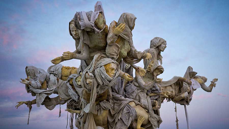 Crown of Womantree at twilight, hooded figures reaching outward against a soft blue and pink sky