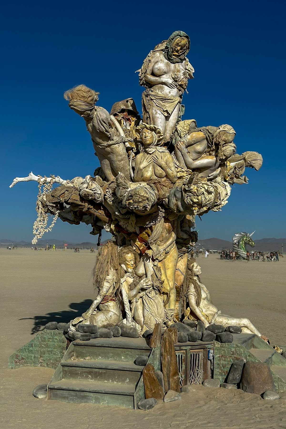 Womantree across the open playa, its branches of cast figures reaching outward