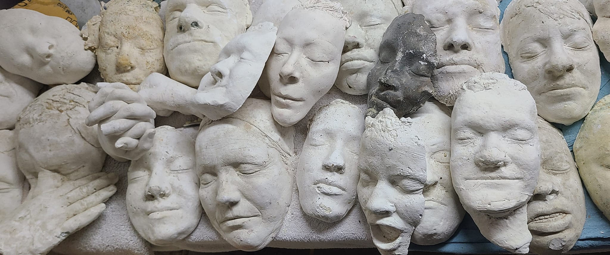 Rows of plaster face casts laid out side by side